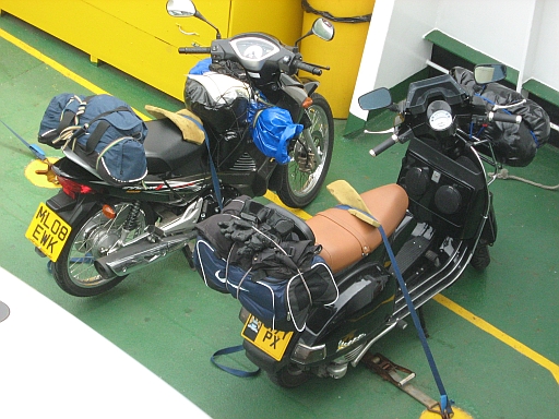 Honda Innova 125 and Vespa 200, loaded with camping gear on the ferry